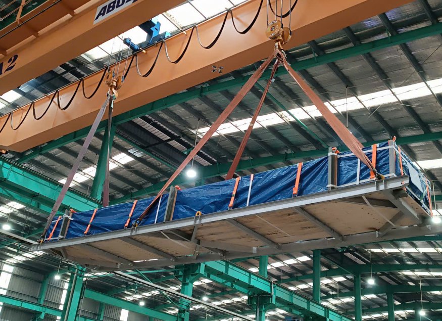 Specialized crane lifting goods, preparing to be loaded into containers)